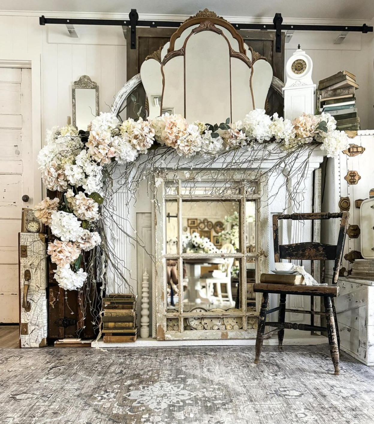 Beautiful antique mantel withold mirrors, books and floral and twig swag / kellyelko.com